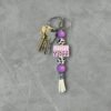 Keychain with metal keys, purple and cow print beads, and a pink "HOWDY Y'ALL" charm.