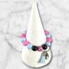 Colorful silicone bead bracelet keychain featuring pink, blue, black, and spotted beads with tassel.