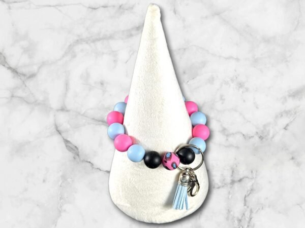 Colorful silicone bead bracelet keychain featuring pink, blue, black, and spotted beads with tassel.