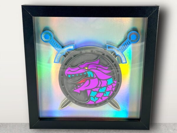 Framed layered art: purple and teal dragon shield with crossed blue swords on iridescent backing.