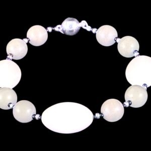 Smoke gray round bead bracelet with 3 large white ovals, silver and black accent spacers, and a silver magnetic clasp, shown against a black background.